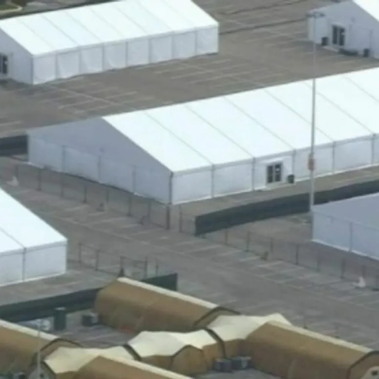 Aerial view of large capacity white tent structures for emergency base camp operations